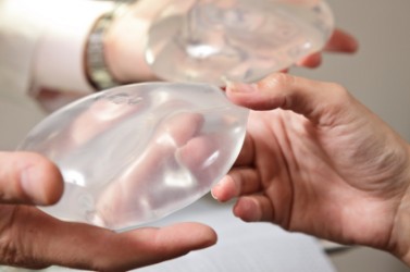 People holding breast implants